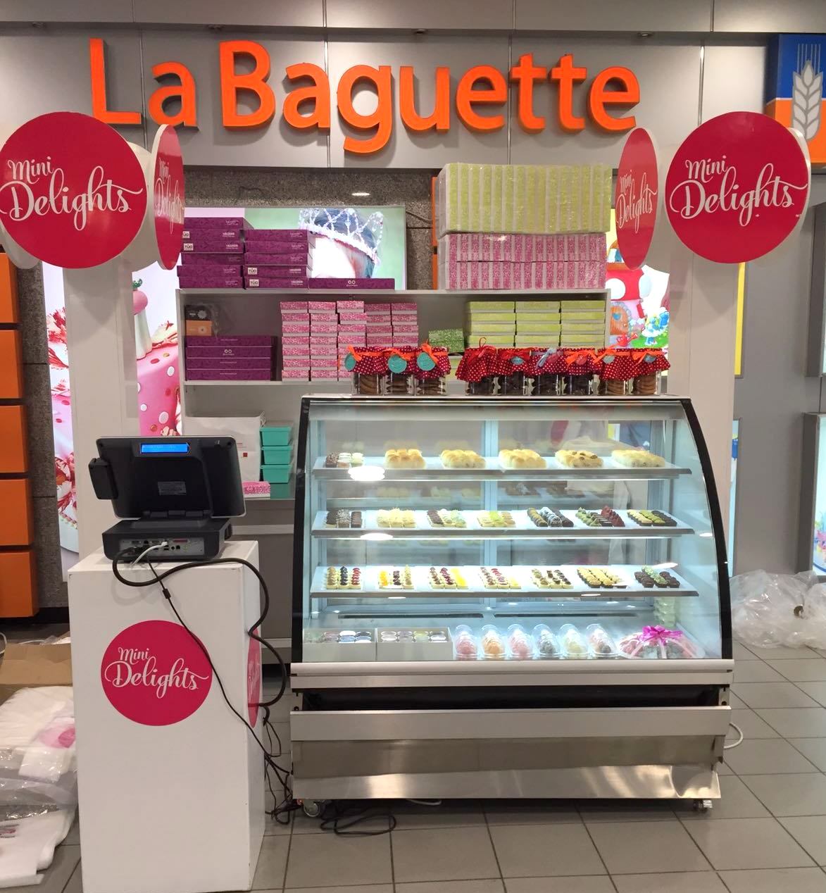 Mini Delights display counter with POS terminal at a La Baguette location in Kuwait